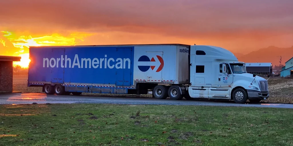 NorthAmerican Moving Truck driving in a sunset
